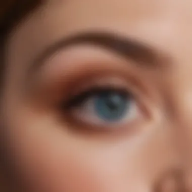 Application techniques demonstrated with Charlotte Tilbury eyeshadow, focusing on creating depth and dimension around blue eyes.