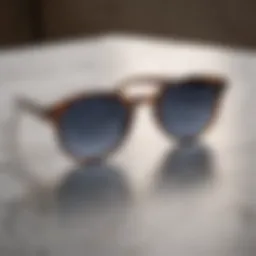 Stylish oval sunglasses on a marble background