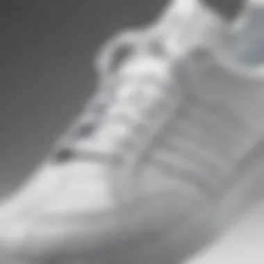 Close-up of Adidas white shoes emphasizing their unique texture and craftsmanship.