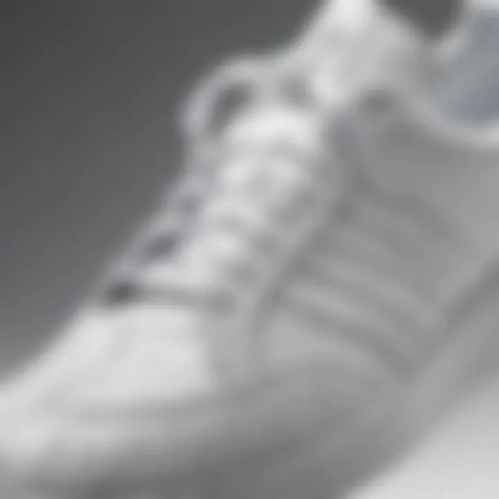 Close-up of Adidas white shoes emphasizing their unique texture and craftsmanship.