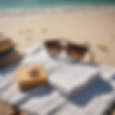 A serene beach with a book and sunglasses laid out on a towel