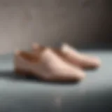 A stylish pair of neutral flat shoes on a minimalist background