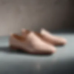 A stylish pair of neutral flat shoes on a minimalist background