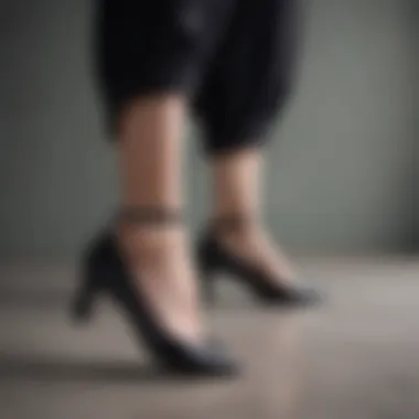 Fashionable woman showcasing black flat shoes in a chic outfit