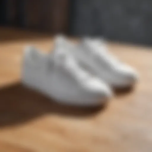 Stylish white sneakers on a wooden surface