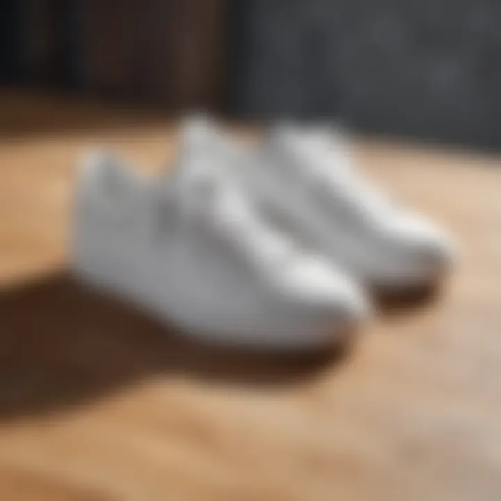 Stylish white sneakers on a wooden surface