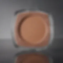 A close-up view of light brown matte eyeshadow in a sleek compact.