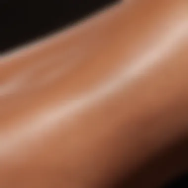 Close-up of skin being applied with a tanning product