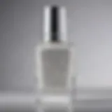 A close-up of sparkling white glitter nail polish in a chic bottle