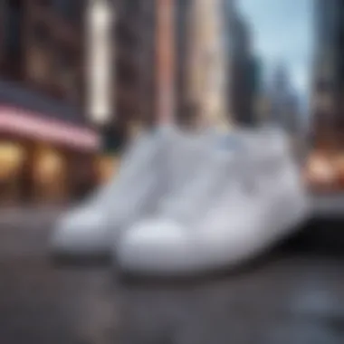 Close-up of all white sneakers against a vibrant urban backdrop.